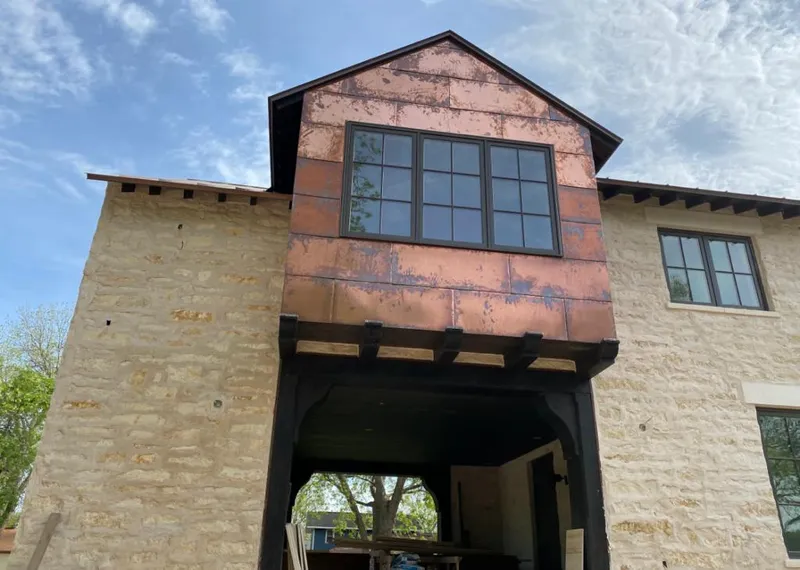 Copper metal panel facade on a stone building for Skylight Installation in East Kapolei